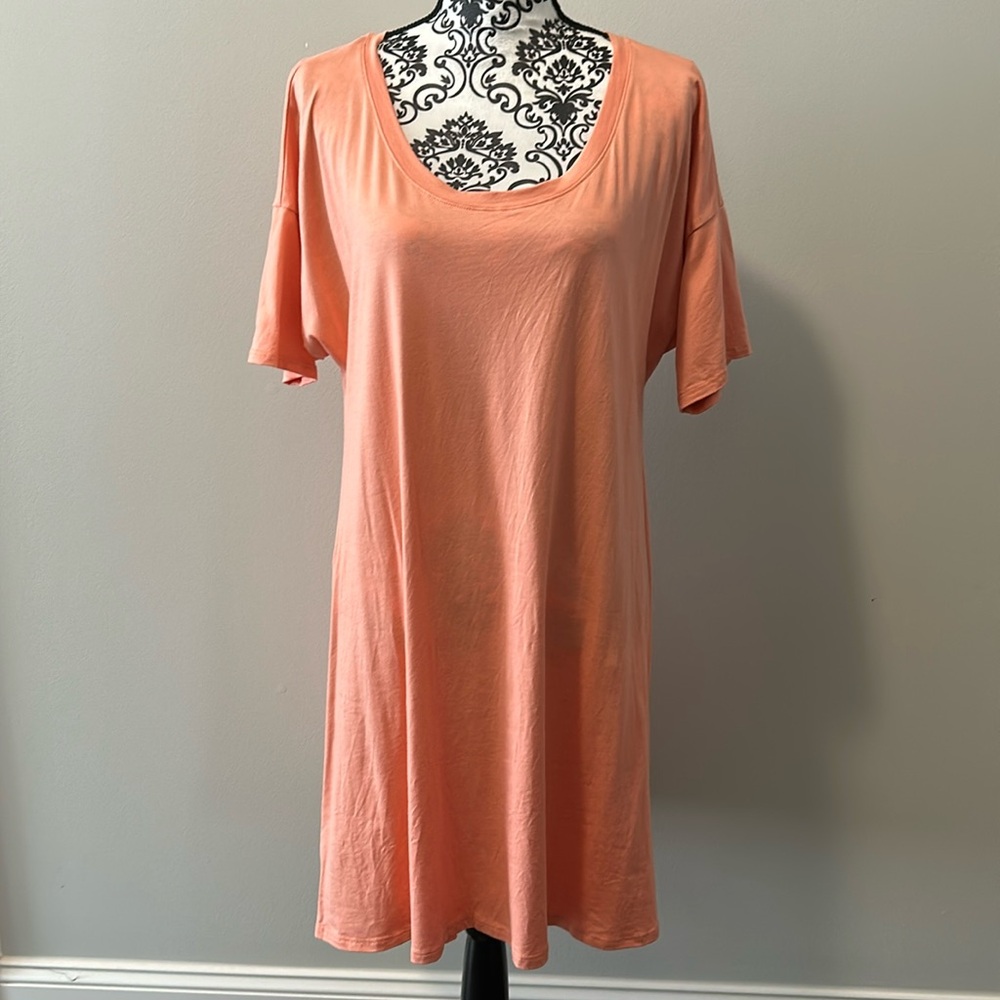 Eluminary woman’s tunic length short sleeve t-shirt in peach/coral color.